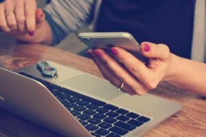 Esthéticienne gérant ses rendez-vous en ligne depuis son smartphone